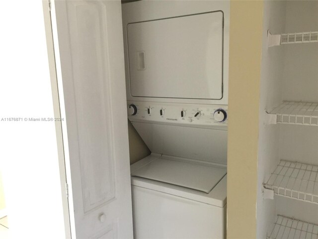 washroom featuring laundry area and stacked washer / dryer