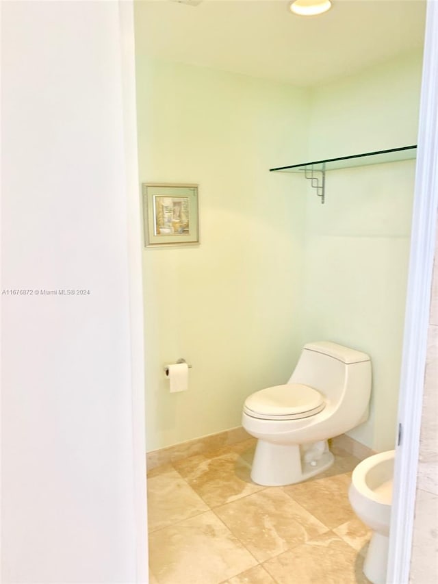 bathroom with toilet and a bidet