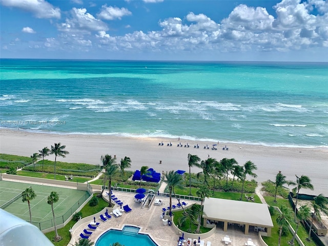 drone / aerial view featuring a water view and a view of the beach