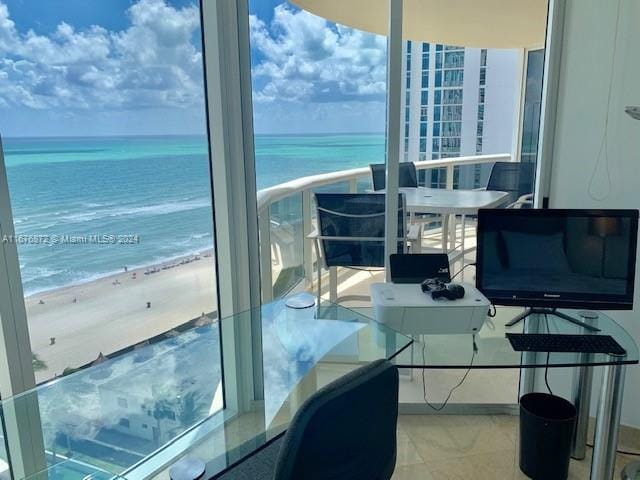 balcony with a water view and a beach view