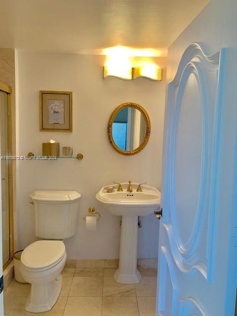 bathroom featuring toilet, walk in shower, and tile patterned flooring