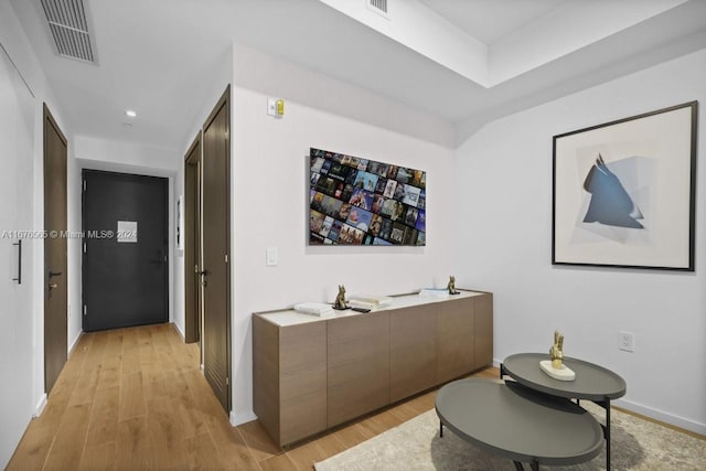 corridor featuring recessed lighting, light wood-style floors, visible vents, and baseboards