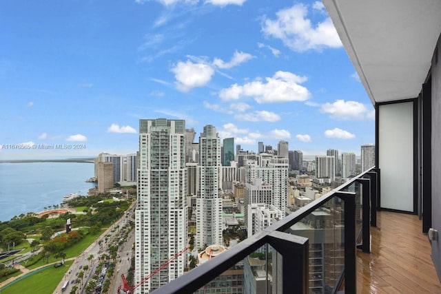 balcony featuring a water view and a view of city