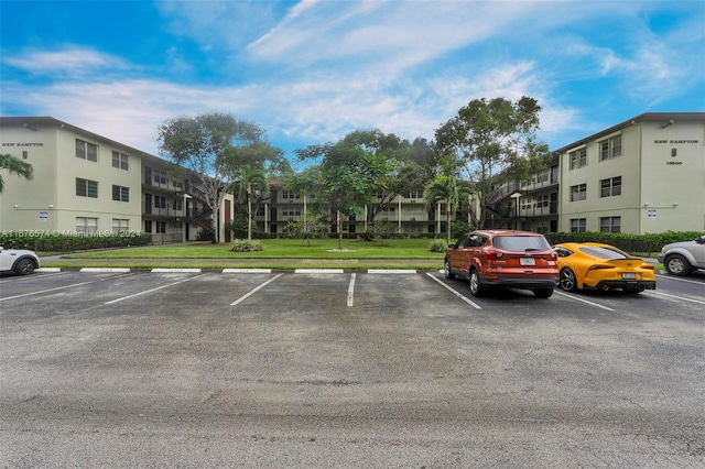 view of parking featuring a lawn