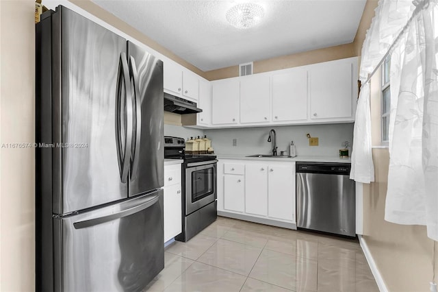 kitchen featuring sink, appliances with stainless steel finishes, a textured ceiling, and white cabinetry