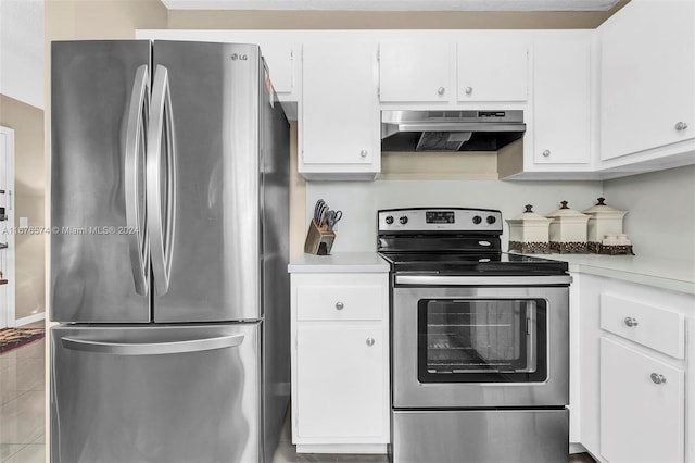 kitchen featuring extractor fan, white cabinetry, and stainless steel appliances