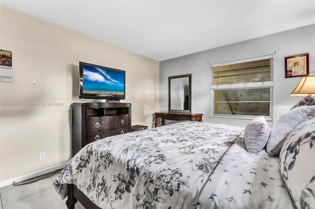 tiled bedroom featuring a textured ceiling