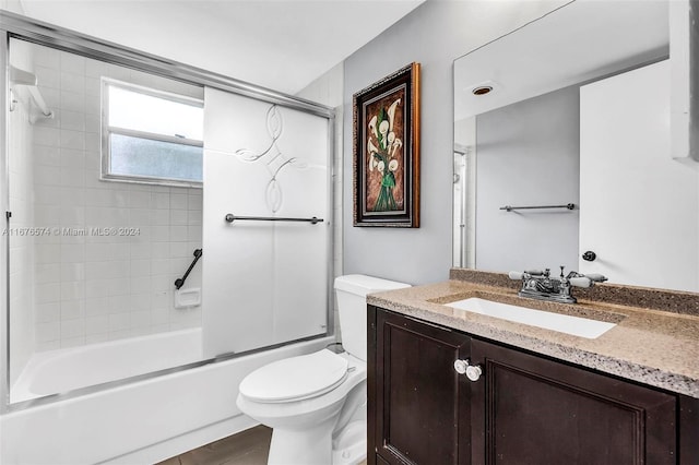 full bathroom with vanity, combined bath / shower with glass door, and toilet