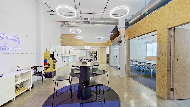 dining space featuring concrete floors