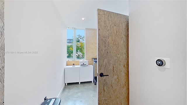 interior space with concrete flooring and floor to ceiling windows