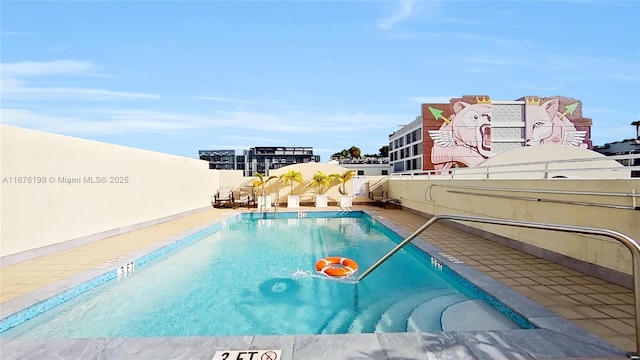 view of swimming pool featuring a beach view