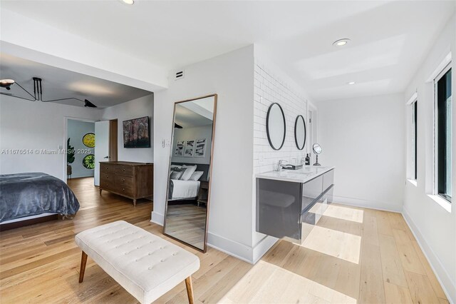 bathroom featuring decorative backsplash, hardwood / wood-style floors, and vanity