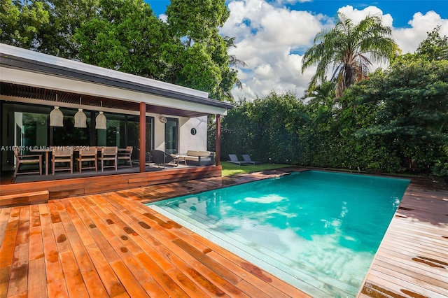 view of pool featuring a deck and an outdoor hangout area