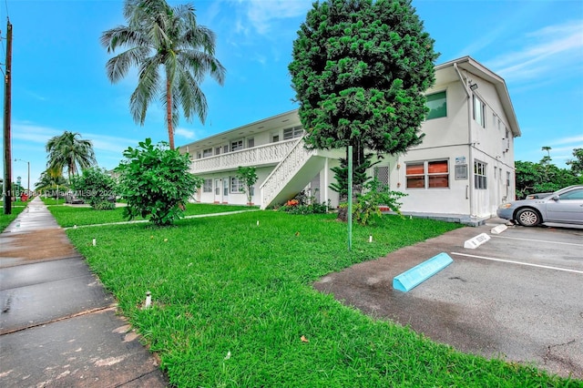 121 NE 204th St Unit 9, Miami Gardens, FL 33179 - view of property featuring uncovered parking and stairway
