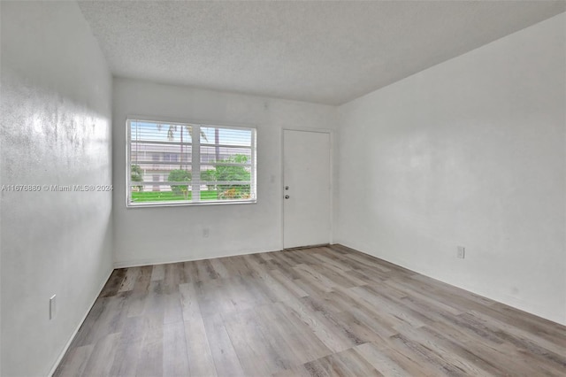 121 NE 204th St Unit 9, Miami Gardens, FL 33179 - empty room with wood finished floors and a textured ceiling