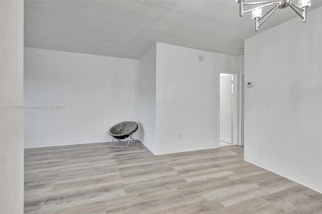 121 NE 204th St Unit 9, Miami Gardens, FL 33179 - unfurnished room with a chandelier, a textured ceiling, and wood finished floors