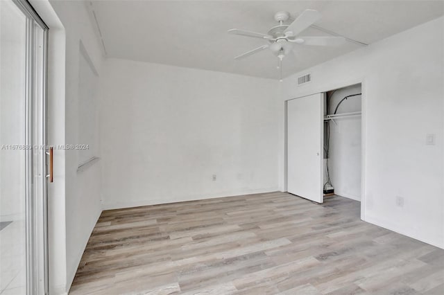 unfurnished bedroom with a closet, light hardwood / wood-style floors, and ceiling fan