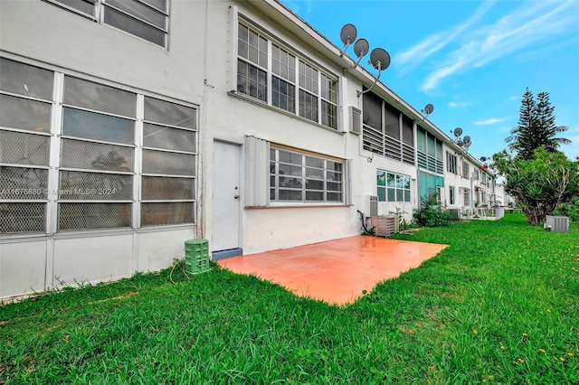 back of property with a patio and a lawn