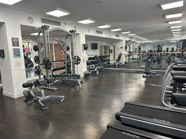 workout area with hardwood / wood-style floors