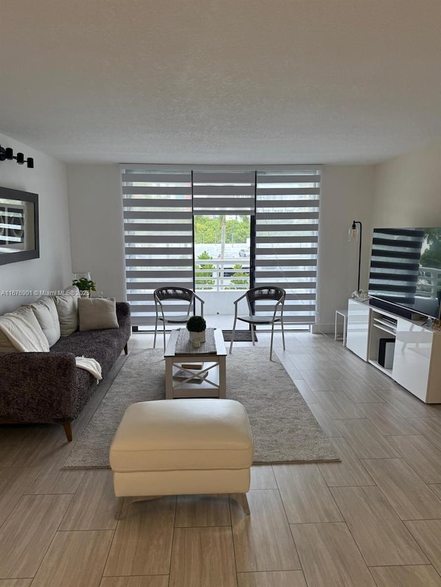 3300 NE 192nd St Unit 414, Aventura, FL 33180 - living room featuring floor to ceiling windows and wood finished floors