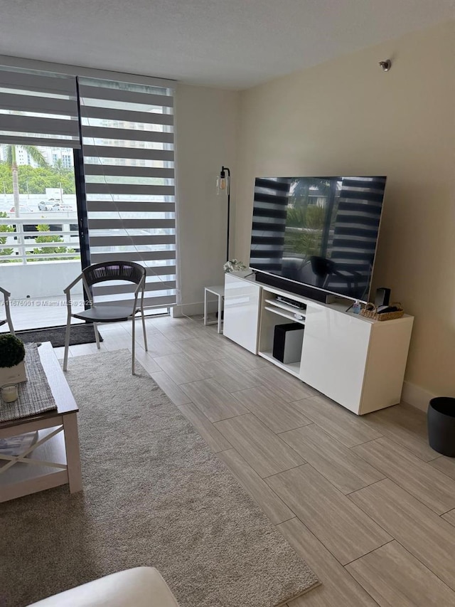3300 NE 192nd St Unit 414, Aventura, FL 33180 - living area with a wall of windows and wood tiled floors