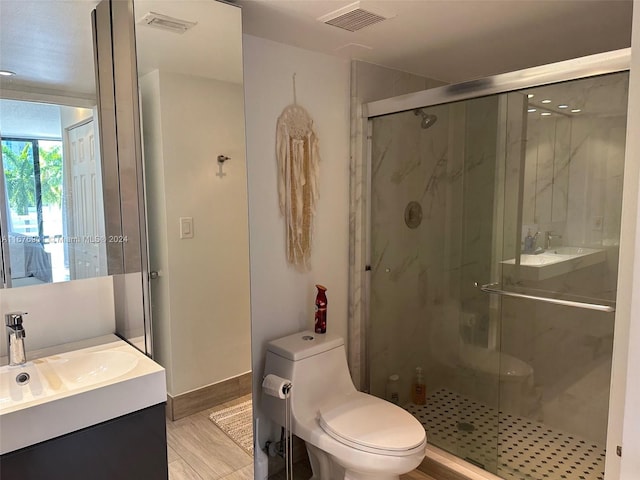 bathroom featuring vanity, toilet, and walk in shower