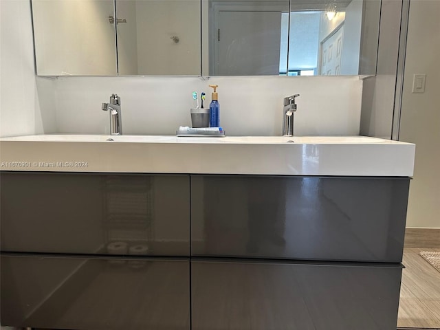 bathroom with vanity and wood-type flooring