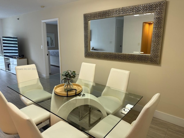 3300 NE 192nd St Unit 414, Aventura, FL 33180 - dining area featuring baseboards and wood finished floors