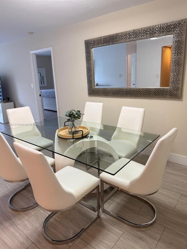 3300 NE 192nd St Unit 414, Aventura, FL 33180 - dining room with baseboards and wood finished floors