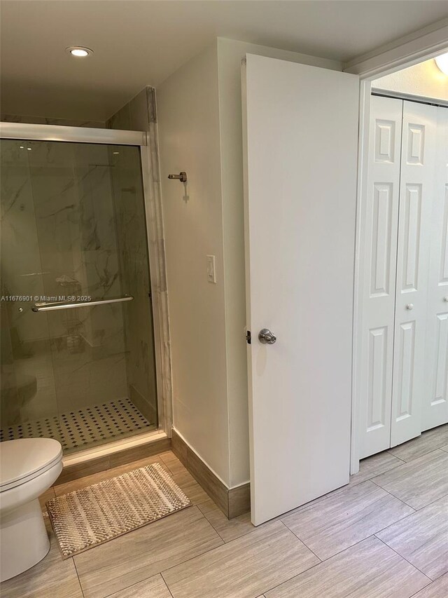 3300 NE 192nd St Unit 414, Aventura, FL 33180 - bathroom featuring a shower stall, wood finished floors, and recessed lighting