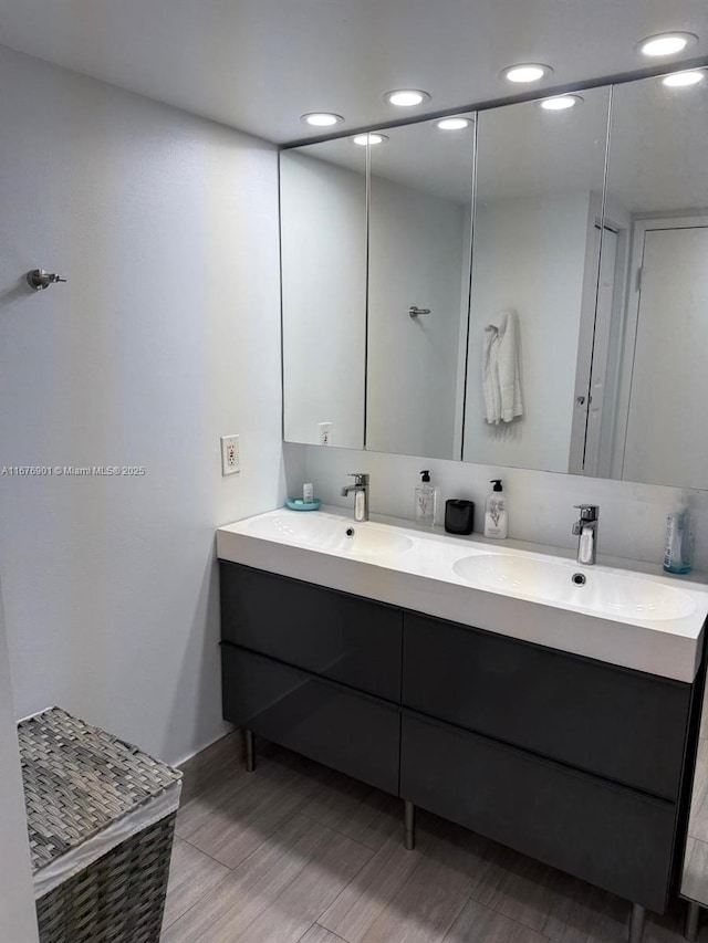 3300 NE 192nd St Unit 414, Aventura, FL 33180 - full bathroom featuring double vanity, recessed lighting, and wood finished floors