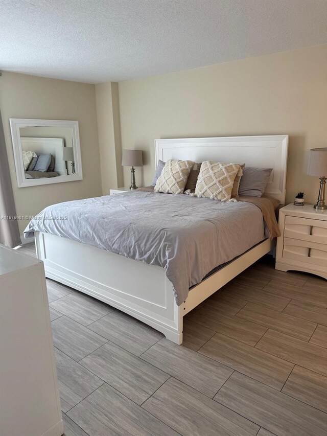 3300 NE 192nd St Unit 414, Aventura, FL 33180 - bedroom with wood finish floors and a textured ceiling