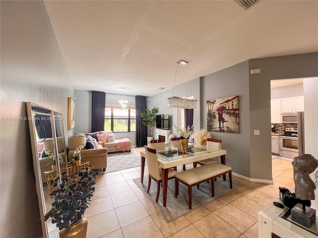 dining space featuring visible vents and light tile patterned floors