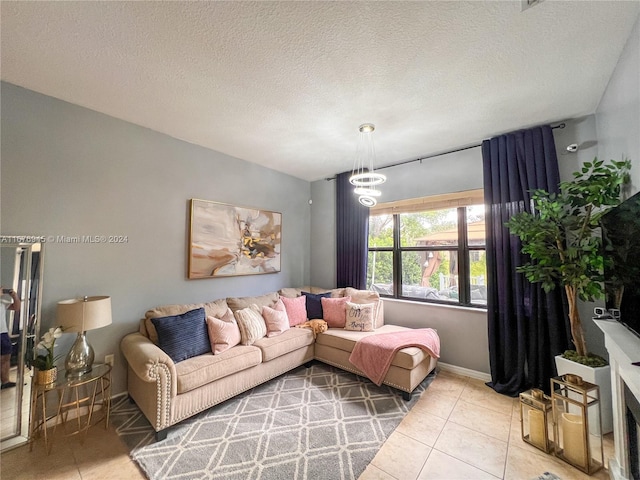 living room with baseboards, a textured ceiling, and light tile patterned flooring