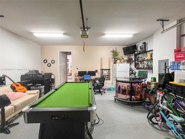 recreation room featuring pool table, a textured ceiling, and electric panel