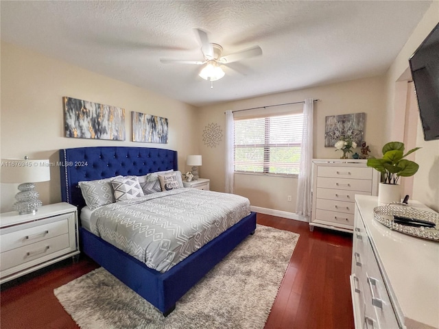 bedroom featuring a textured ceiling, dark hardwood / wood-style floors, and ceiling fan