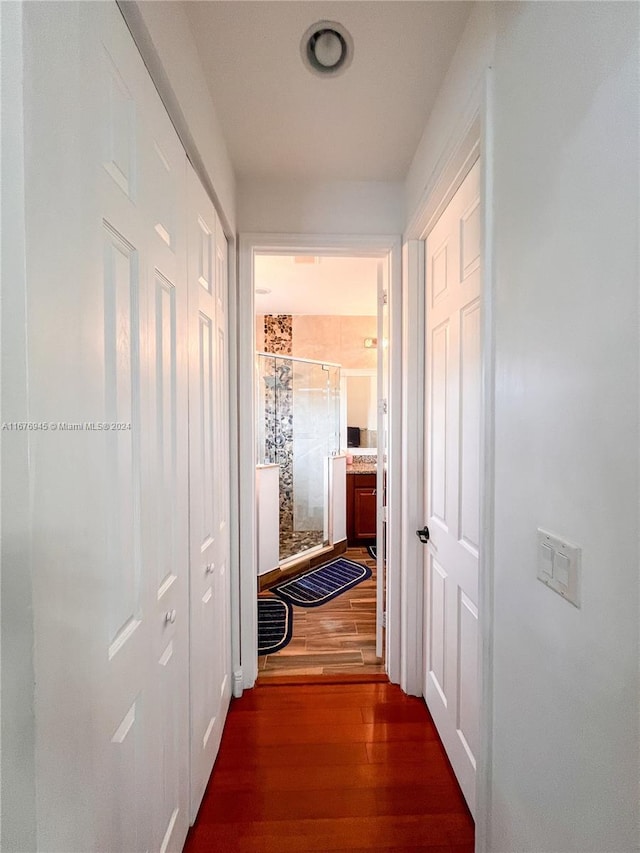 corridor with dark wood-type flooring