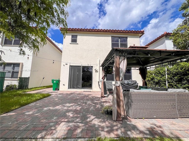 back of property featuring a gazebo, a patio area, and an outdoor hangout area