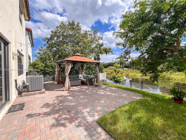 view of patio with a gazebo, central AC unit, and a water view