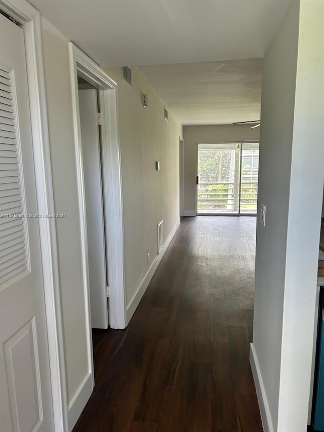 corridor with dark hardwood / wood-style floors