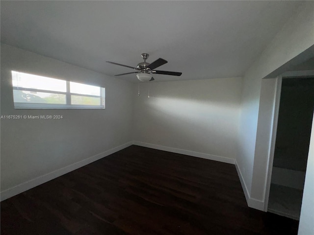 empty room featuring dark wood-type flooring and ceiling fan