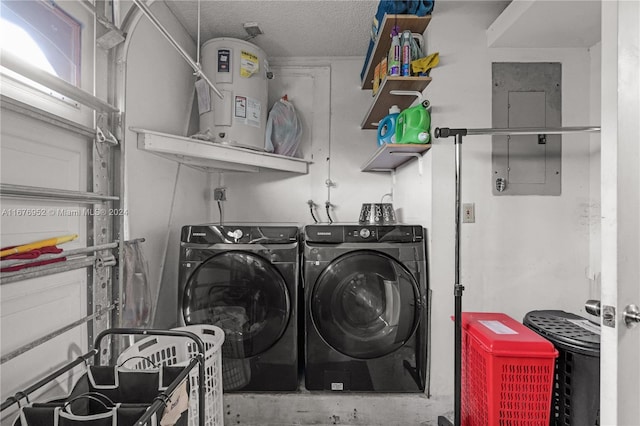 clothes washing area featuring electric panel, electric water heater, washing machine and dryer, and a textured ceiling