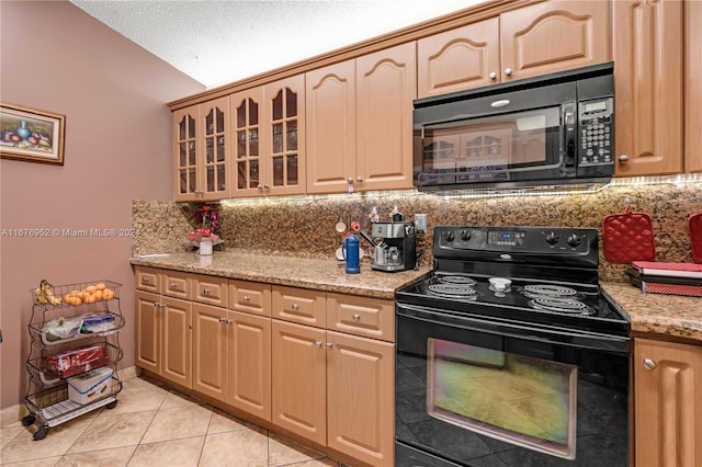 kitchen featuring decorative backsplash, black appliances, light tile patterned floors, light stone counters, and a textured ceiling