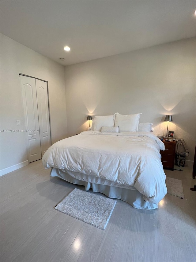 bedroom featuring light wood-type flooring and a closet