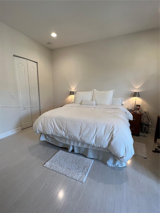 bedroom with a closet and light hardwood / wood-style flooring