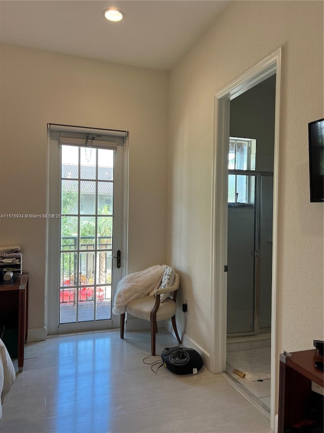 doorway to outside with light hardwood / wood-style floors and plenty of natural light