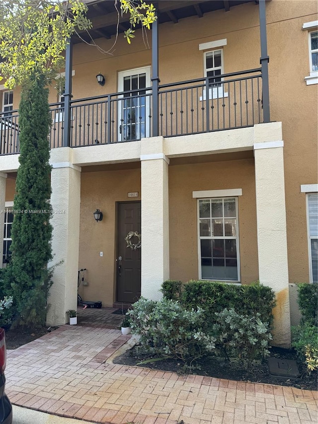 entrance to property with a balcony