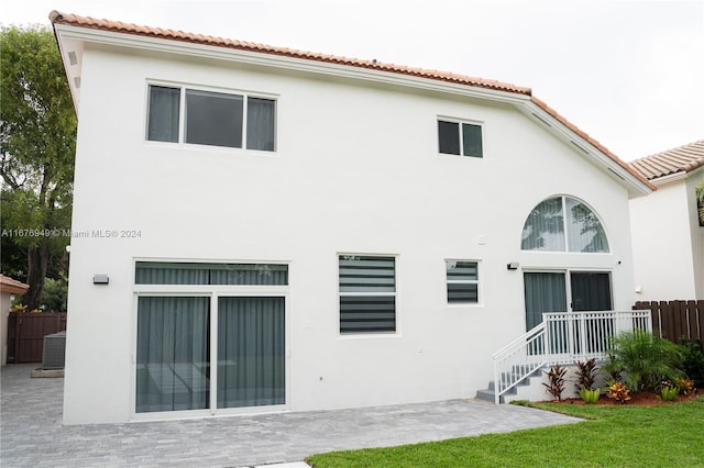 rear view of property featuring a patio area and central AC unit