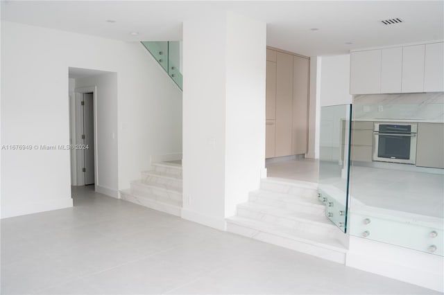 stairs featuring tile patterned flooring