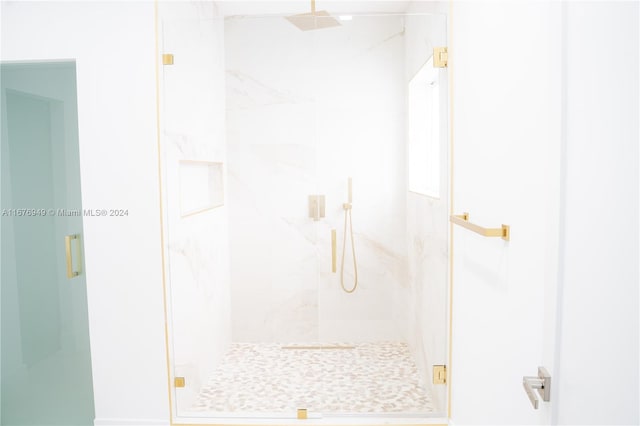 bathroom with a shower with door